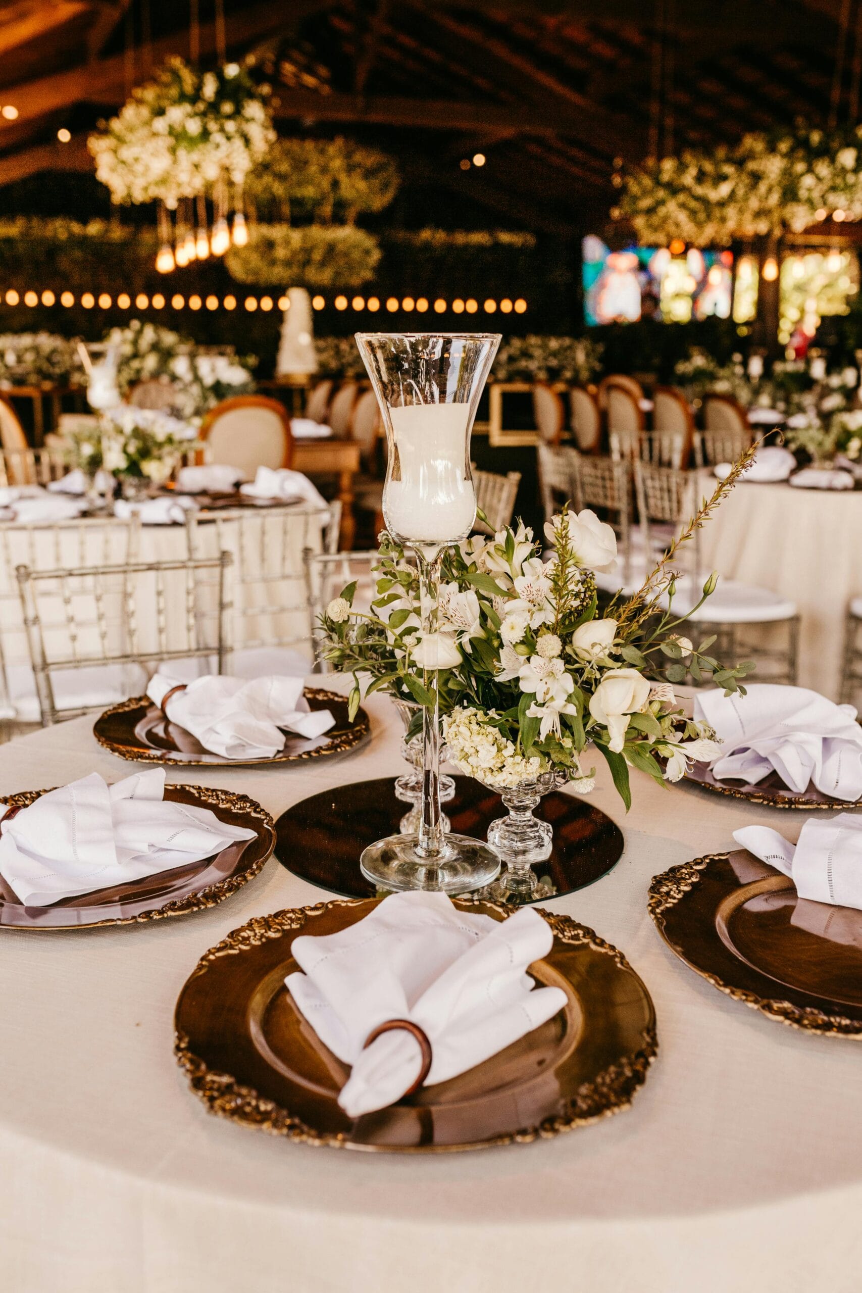 Beautifully decorated wedding reception table with elegant place settings and floral centerpiece.