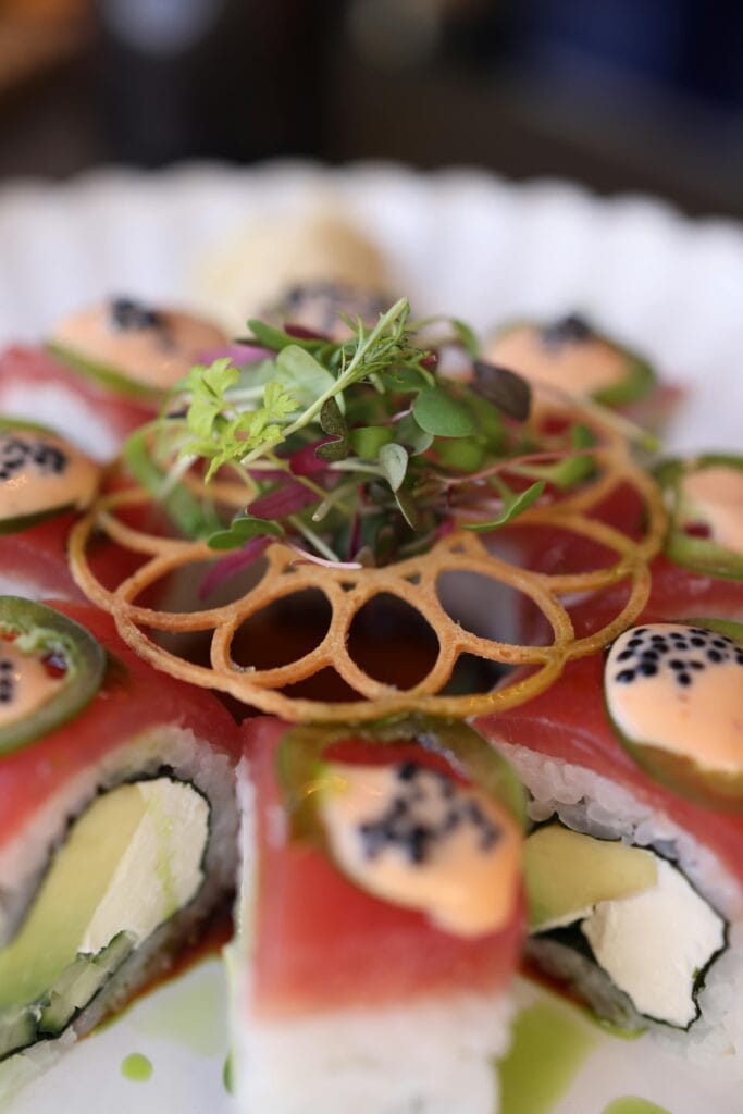 Beautifully arranged sushi with intricate garnish and fresh ingredients, perfect for culinary inspiration.